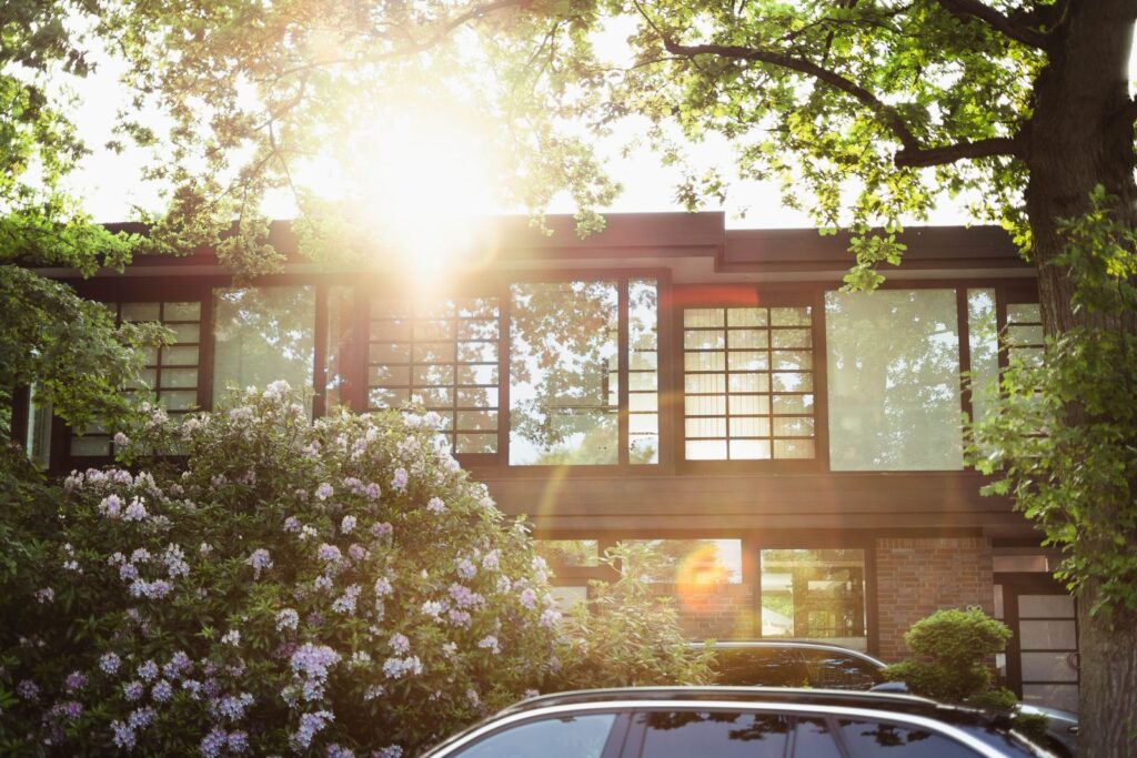 Midcentury modern house with glass walls at dusk