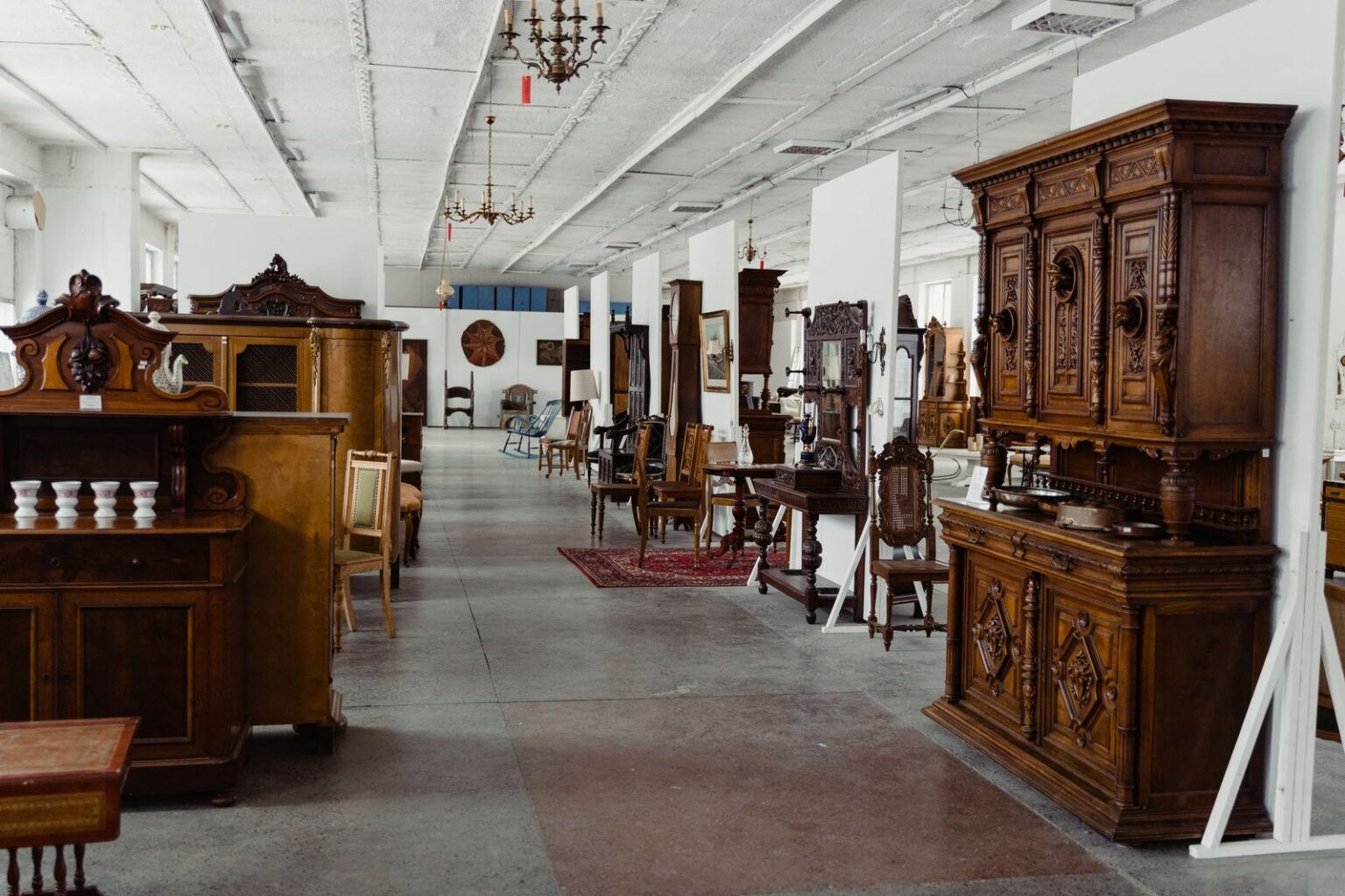 Vintage furniture shop interior stacked with midcentury pieces