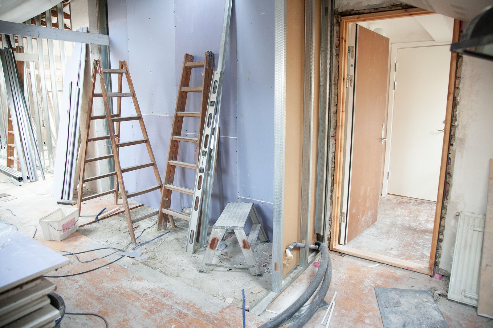 House interior mid-renovation with bare walls and construction materials