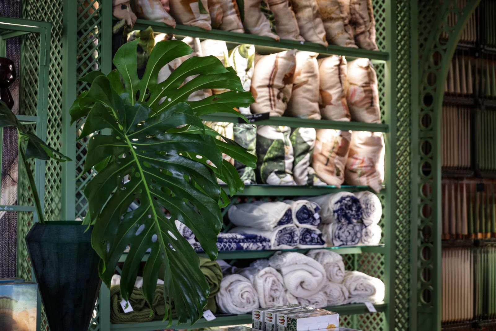 Store interior with green decor and textiles arranged on display