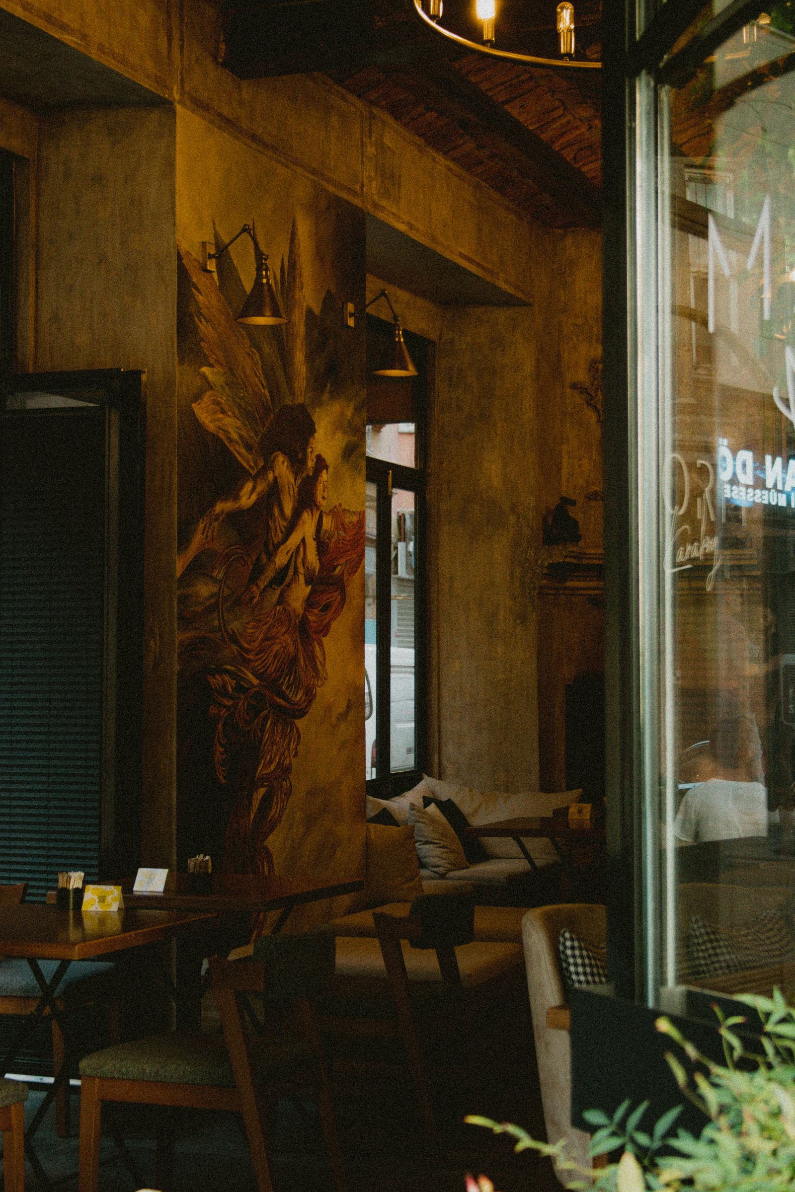 Restaurant dining room with minimal decor and pendant lighting