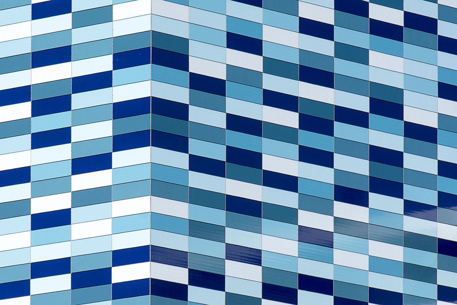 Blue and white glass facade of a large modern building