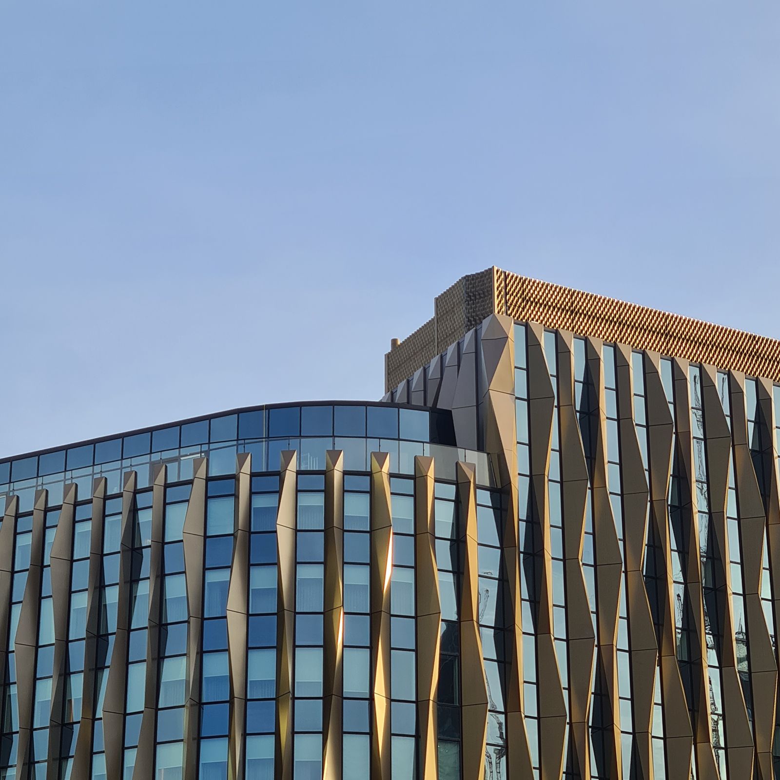 Modern office building facades of glass and metal against a clear sky