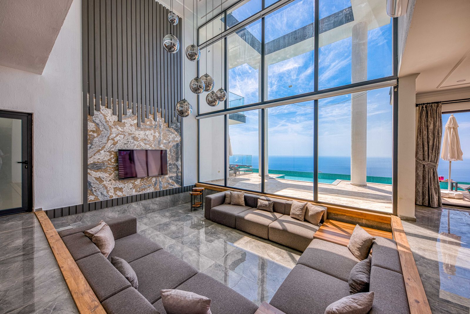 Modern living room with a wide window looking out to the ocean