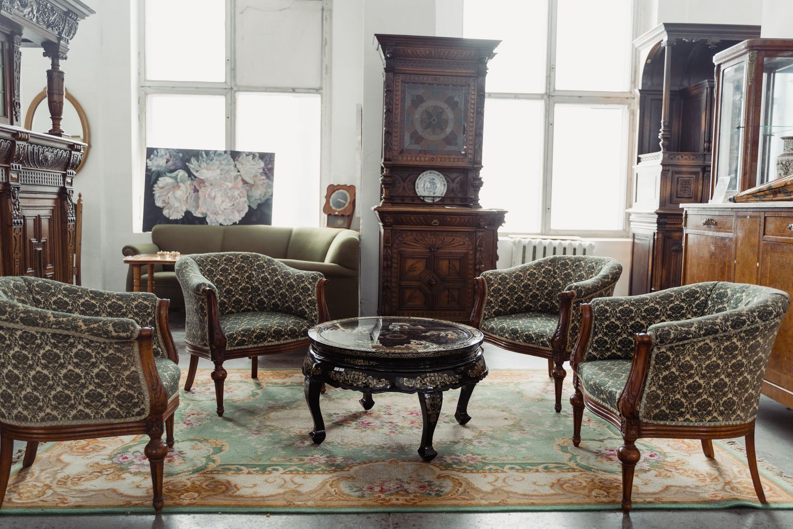 Antique shop crowded with old furniture, chandeliers and upholstered sofas