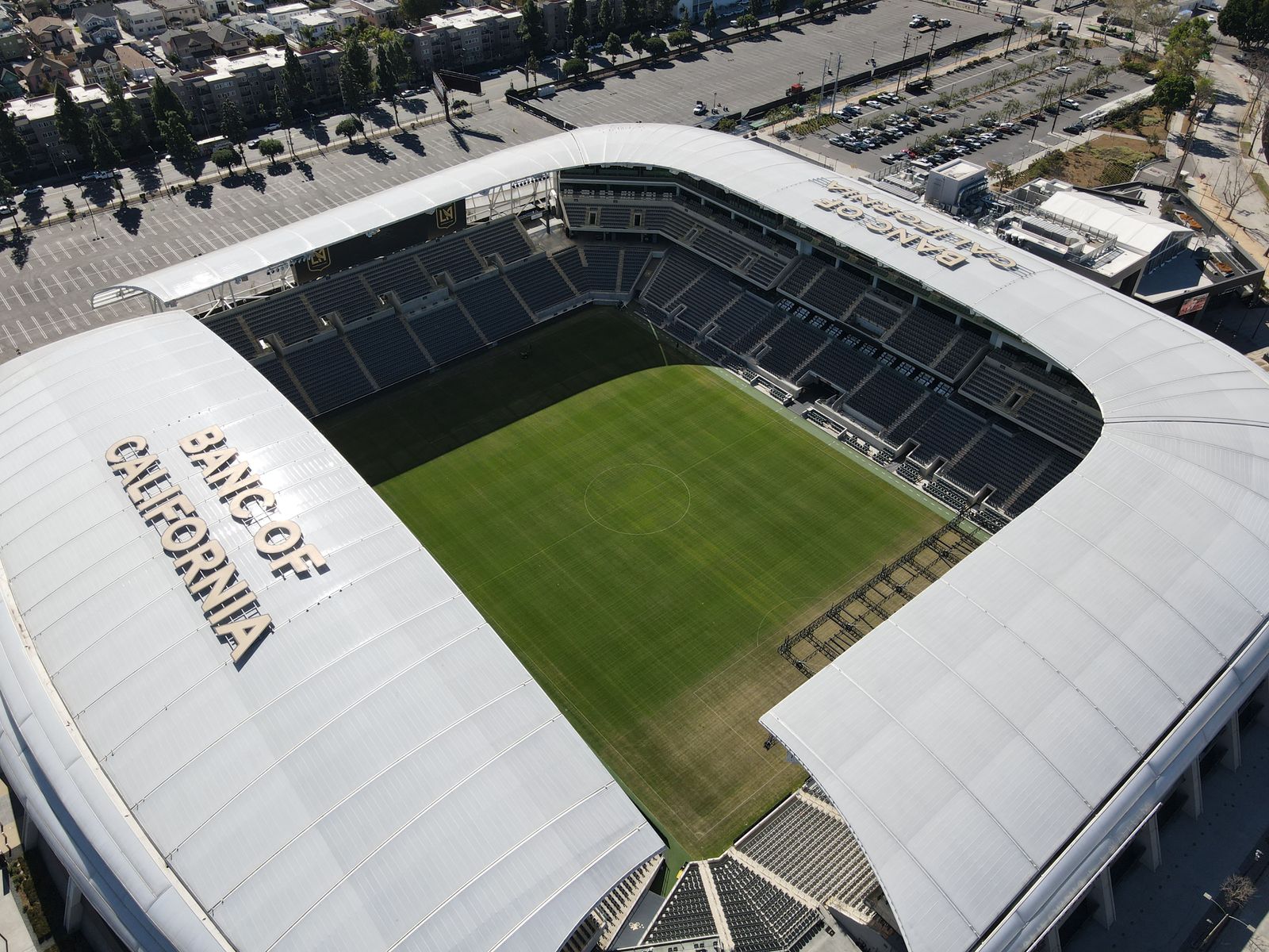 Aerial view of a modern soccer stadium and its surrounding grounds